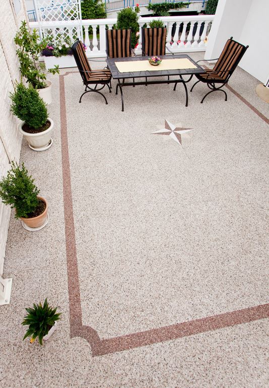 Wunderschöne Terrasse mit toskanischen Stil mit beigen Steinteppich-Boden.